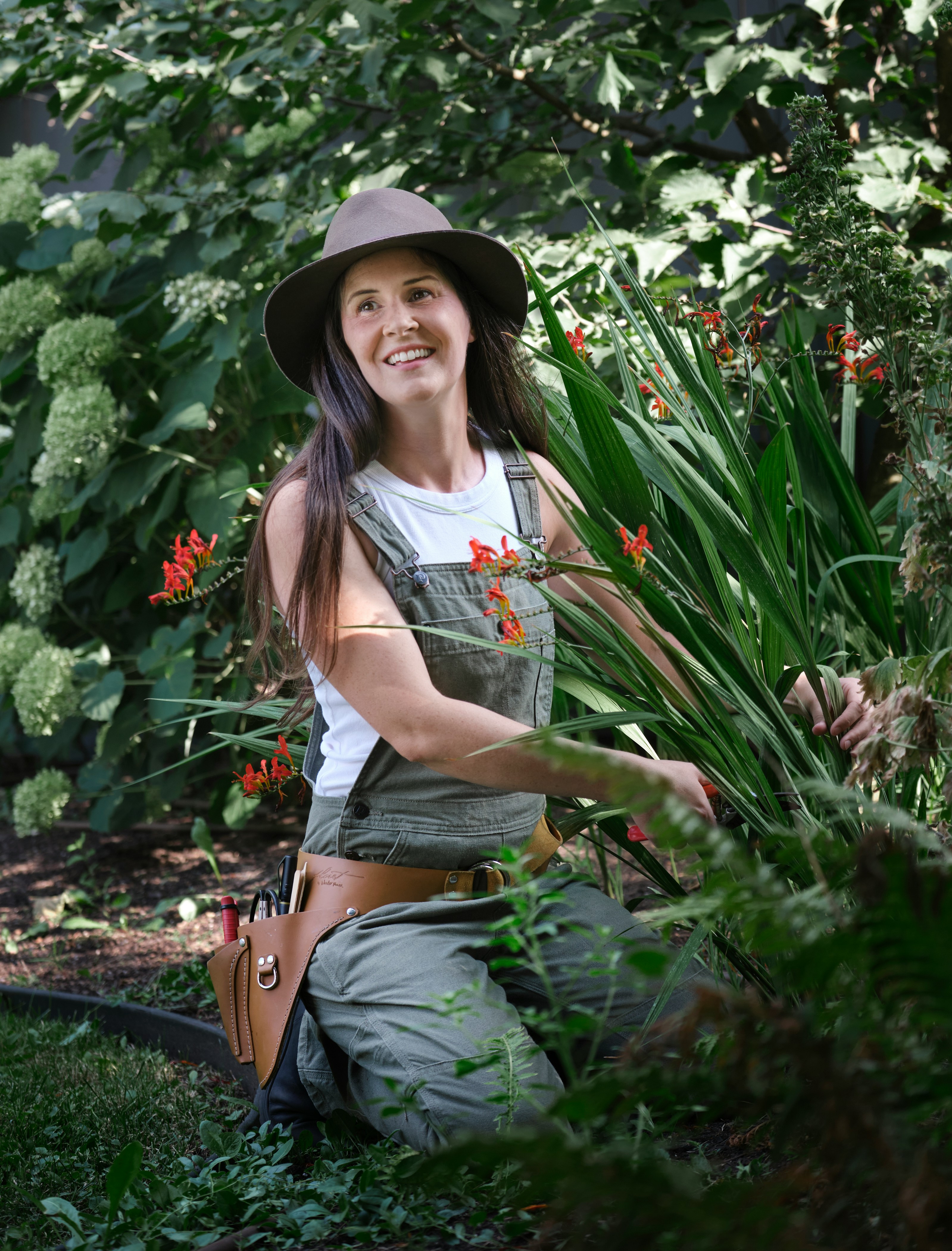 Jean smiling while tending her garden